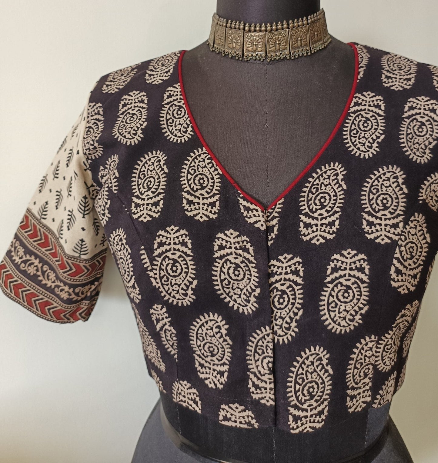 black gamathi blouse with beige sleeves